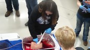 Stop the Bleed Training - Students using gauze with fake blood being pushed through to simulate the process.